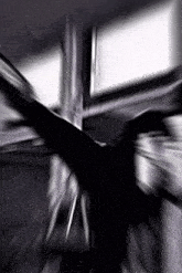 a blurry picture of a person 's face in a dark room with a window