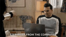 a man sitting at a table with a laptop and the words step away from the computer