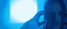 a person with dreadlocks is wearing headphones in a blue light