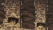 a stone wall with wooden boards on it