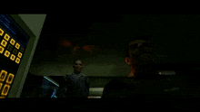 a man in a video game is talking to another man in front of a red light