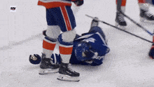 a hockey player is laying on the ice with the sn logo on the bottom