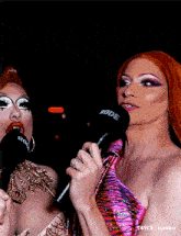 two drag queens are holding microphones that say rode