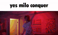 a woman is dancing in a room with red lights and the words yes milo conquer above her