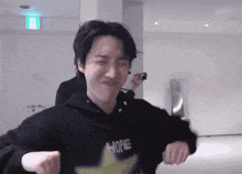 a man wearing a hoodie that says hope is making a funny face