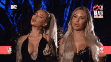 two women standing next to each other in front of a sign that says ex on the beach double dutch