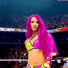 a woman with purple hair is standing in a ring .