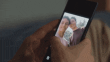 a person is taking a picture of two men on their phone