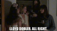 a group of women are standing next to each other holding wine glasses and talking .