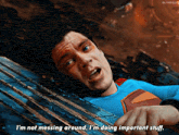a man in a superman costume is laying down and saying i 'm not messing around