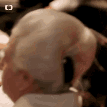 a close up of an elderly woman wearing headphones .