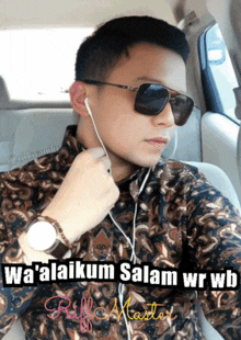 a man wearing sunglasses and ear buds is sitting in a car with a caption that says wa'alaikum salam
