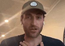 a man wearing a hat with a patch that says outer north apparel
