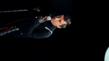 a man is singing into a microphone with a jacket that says jettum on the sleeve