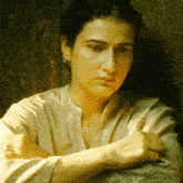 a woman with her arms crossed is wearing a necklace with a star