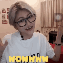 a woman wearing glasses and a shirt that says wowwww