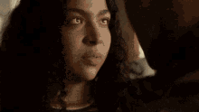 a man and woman are looking at each other in a room .