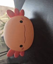 a pink axolotl with a black nose and mouth
