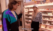 a man and a woman are standing next to each other in a store and the woman is saying mullet are dope .