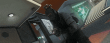 a man in a mask is holding a gun in a room