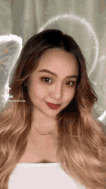 a close up of a woman 's face with angel wings