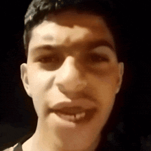 a close up of a man 's face with his mouth open and his teeth showing