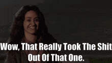 a woman is smiling with the words wow that really took the shit out of that one behind her