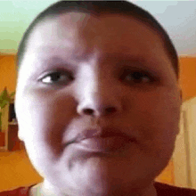 a close up of a person 's face with a serious look on their face .