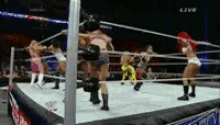 a group of women are wrestling in a ring with the word live on the bottom