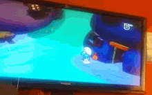 a toshiba television shows a smurf cartoon on channel 5