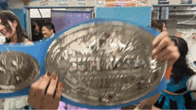 a woman is holding a trophy that says futures