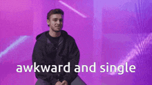 a man is sitting in front of a purple background with the words awkward and single