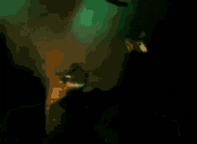 a blurry picture of a person in a dark room with a green background