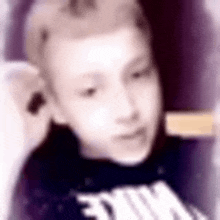 a blurry picture of a boy wearing a nike shirt