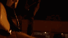 a man in a black shirt is standing next to a white suv at night