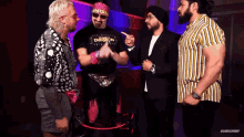 a group of men are standing next to each other and one of them has a shirt that says dungeon on it