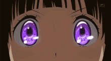 a close up of a girl 's eyes with purple circles