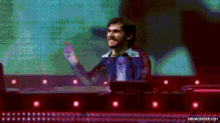 a pixelated image of a man standing in front of a computer screen