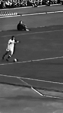 a black and white photo of a soccer game being played