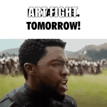 a man with a beard is standing in front of a crowd and says artafight tomorrow .