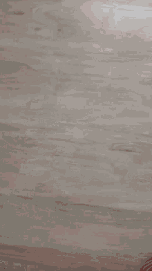a close up of a person 's middle finger on a wooden floor