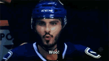 a hockey player wearing a helmet that says ccm says woo