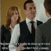 a man in a suit and tie is talking to a woman in a white shirt