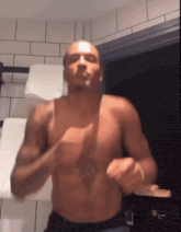 a shirtless man is dancing in front of a window in a bathroom
