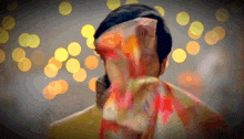 a woman covering her face with a scarf with a blurred background