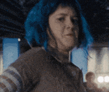 a woman with blue hair and a striped shirt
