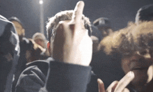 a man giving the middle finger in front of a crowd of people