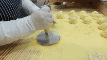 a bunch of dough balls on a wooden table with the words made in animatica on the bottom