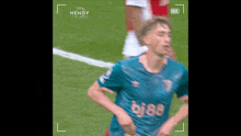 a soccer player wearing a blue jersey with the word bj88 on it is running on a field .