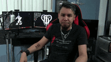 a man with a tattoo on his arm is wearing a shirt that says it 's dangerous to go zone take this